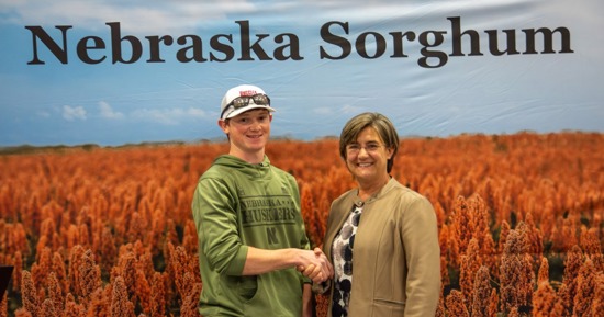 Nathan Rippe, left, receives a Nebraska Sorghum Producers Scholarship from Chair Tracy Zink at the 2026 Nebraska Sorghum Appreciation Banquet in Grand Island, Thursday, March 12, 2026. (Nebraska Sorghum Photo/Jesse Harding Campbell)