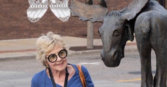 Photo Courtesy GI Tourism: Nancy Fisher takes a look at Moose on the Loose, created by former Hastings veterinarian David Biehl. 